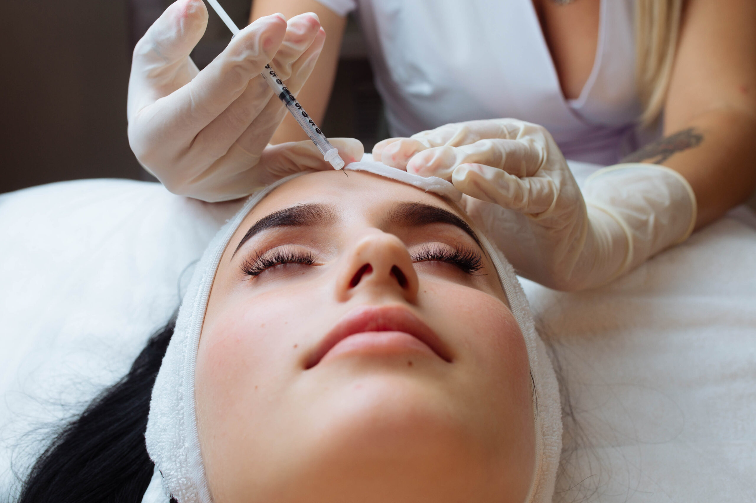 The doctor cosmetologist makes the Rejuvenating facial injections procedure for tightening and