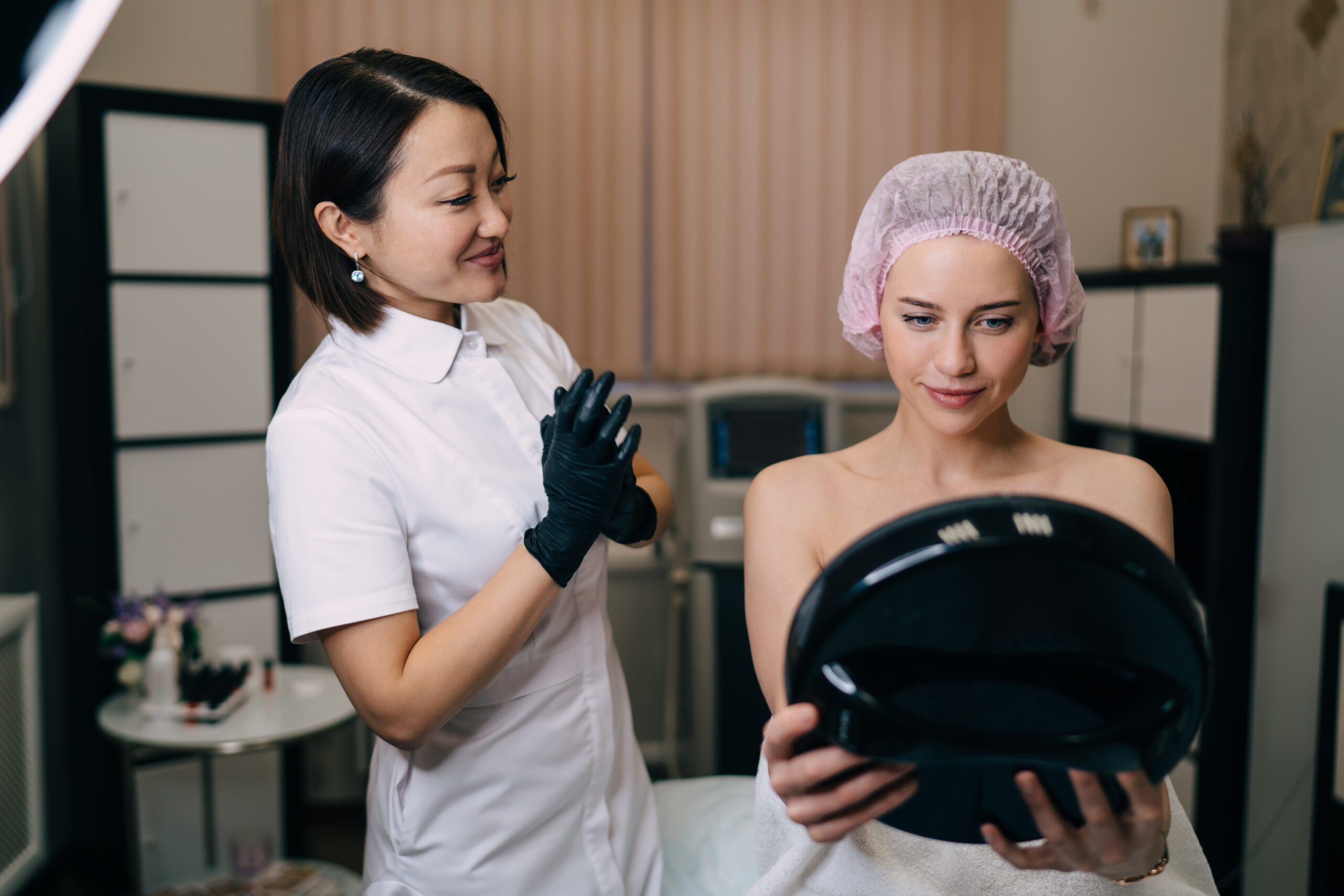 Women looking at mirror after botox injection