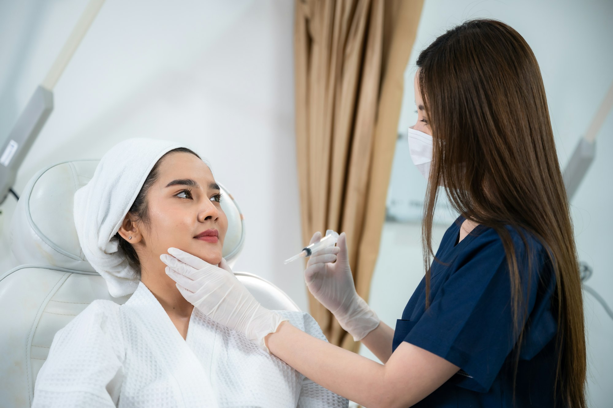 young Asian woman having oedema after face injection