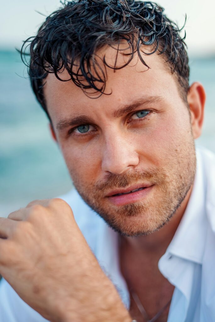 Handsome man with wet hair at seaside. He had hair transplant by the past.