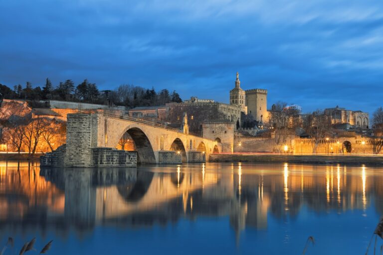 Old bridge and city skyline at dusk in Avignon, France hair transplant center at avignon