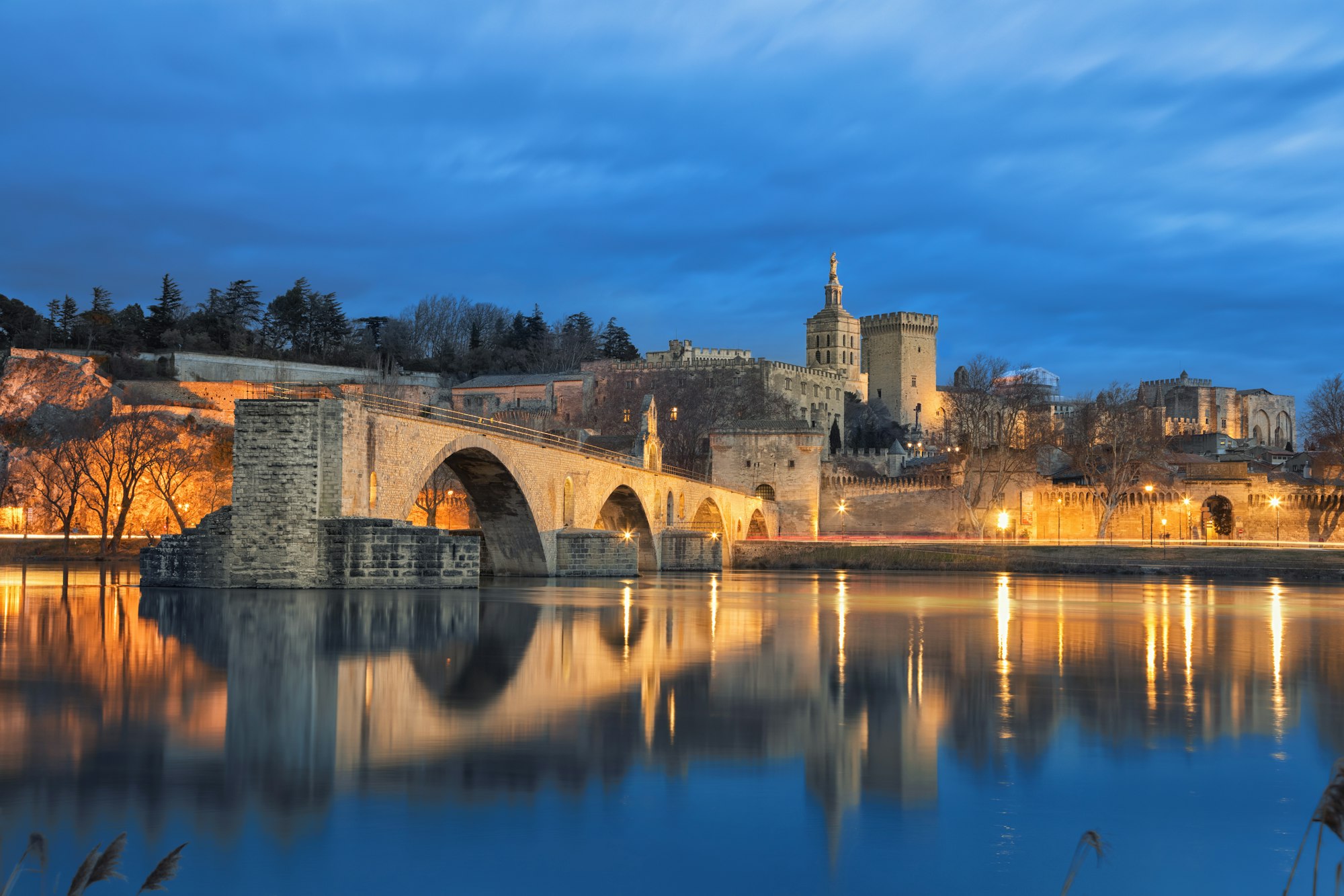 Old bridge and city skyline at dusk in Avignon, France hair transplant center at avignon