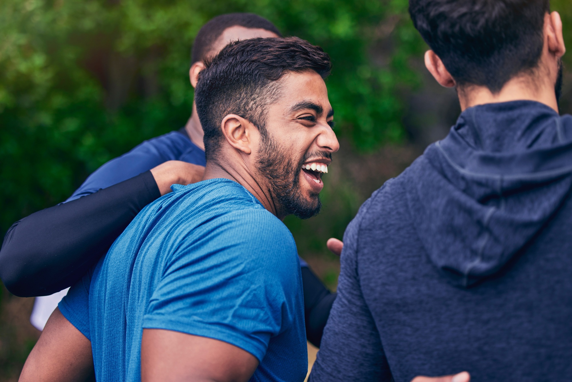 Happy, men and friends laughing for fitness, workout and running outdoor with a smile. Exercise, tr