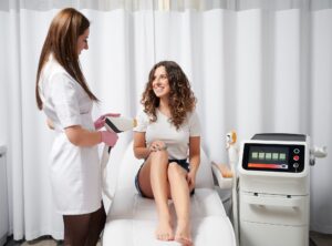 Joyful woman receiving laser hair removal treatment in beauty salon.