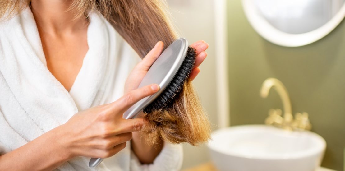 Combing hair in the bathroom