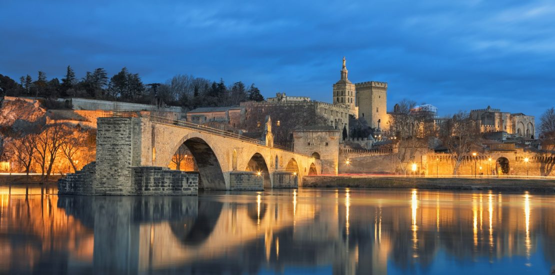 Old bridge and city skyline at dusk in Avignon, France hair transplant center at avignon